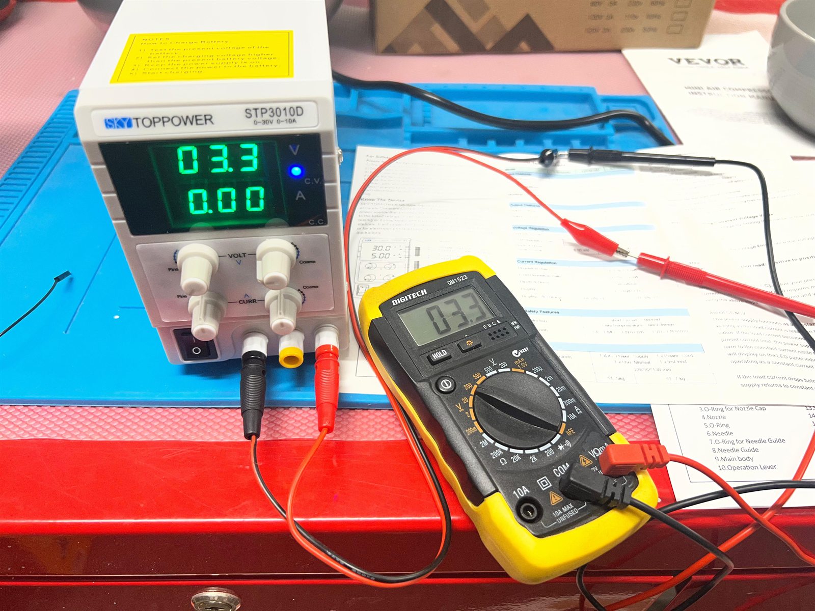 The SKY TOPPOWER STP3010D bench supply set to 3.3 volts, with the multimeter also reading 3.3 volts